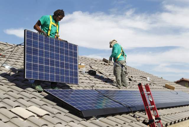 The SolarCity workers install rooftop panels. (Source: Las Vegas Review-Journal)