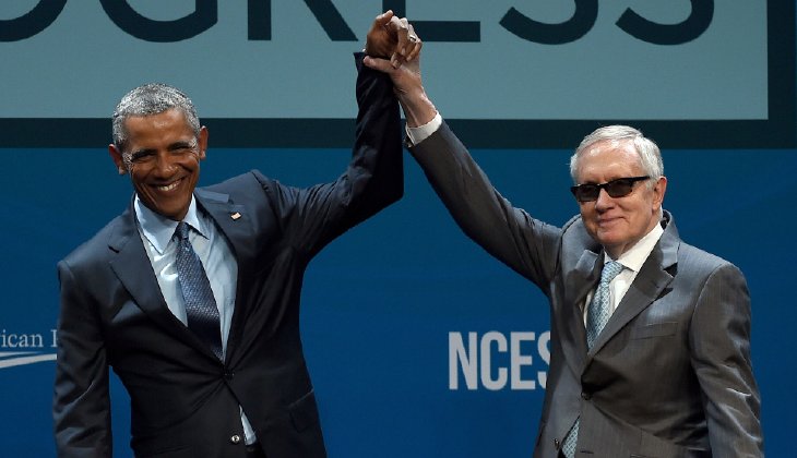 President Barack Obama and Senate Minority Leader Harry Reid  gesture after Obama delivered the keynote address at the National Clean Energy Summit 8.0. (Photo by Ethan Miller, Getty Images)