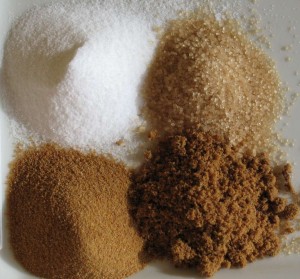 Clockwise from top left: White refined sugar, unrefined sugar, brown sugar, unprocessed cane sugar. (Courtesy: Wikimedia Commons)