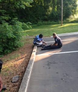 Officer Tim Purdy of the Charlotte Mecklenburg Police Department in North Carolina pacifies a teenager, who is suffering from autism and has a history of violent behavior, after running out from his campus. (Courtesy: Charlotte Mecklenburg Police Department)